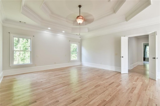 5121 Hope Ct SW, Lilburn, GA 30047 - spare room featuring a tray ceiling, ornamental molding, light wood-style floors, ceiling fan, and baseboards
