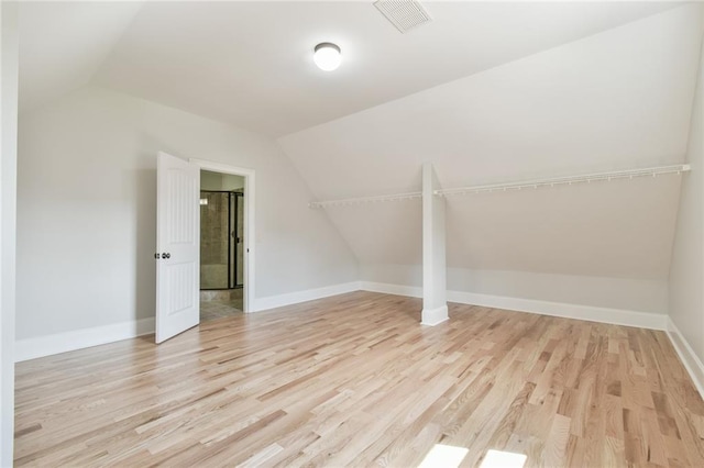 5121 Hope Ct SW, Lilburn, GA 30047 - additional living space with lofted ceiling, light wood-style floors, and baseboards
