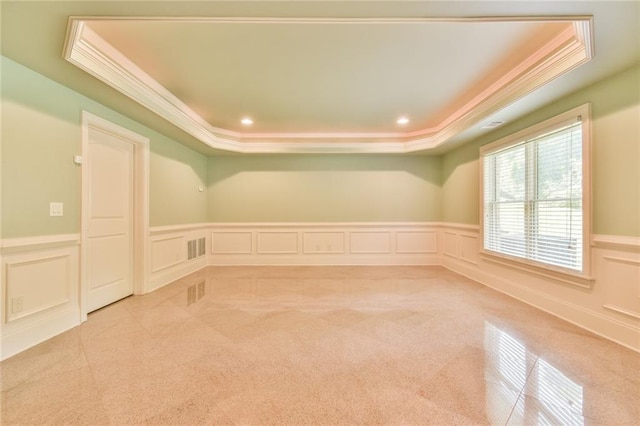 5121 Hope Ct SW, Lilburn, GA 30047 - spare room featuring crown molding, a tray ceiling, light carpet, a decorative wall, and wainscoting