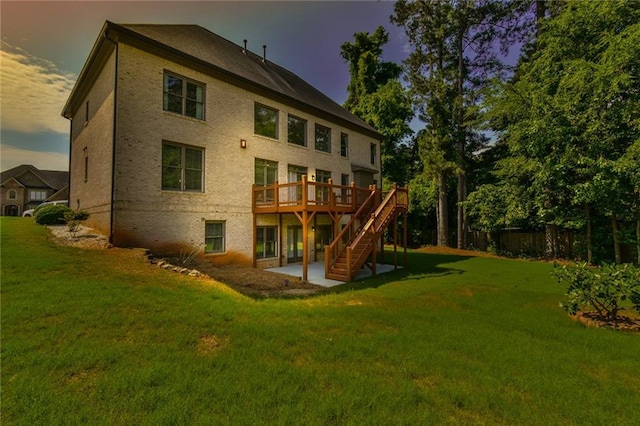 5121 Hope Ct SW, Lilburn, GA 30047 - back of house featuring a deck, a patio, stairs, and brick siding