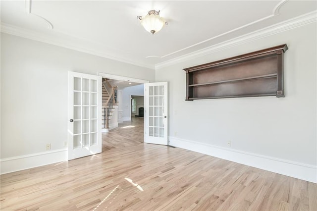5121 Hope Ct SW, Lilburn, GA 30047 - unfurnished room featuring french doors, stairs, crown molding, light wood-type flooring, and baseboards