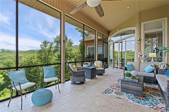 sunroom / solarium featuring ceiling fan, wood ceiling, and plenty of natural light