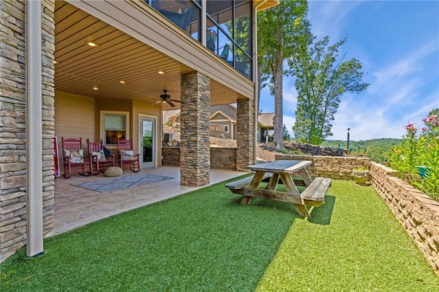 view of yard featuring a patio and ceiling fan