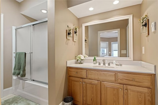 bathroom with vanity and shower / bath combination with glass door