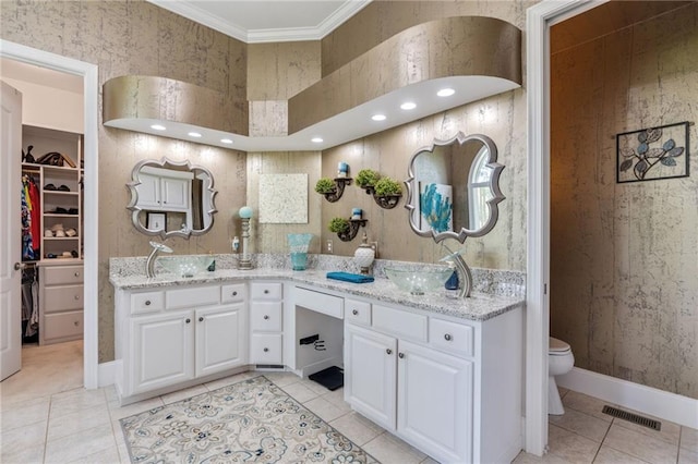 bathroom featuring ornamental molding, tile patterned flooring, and double vanity