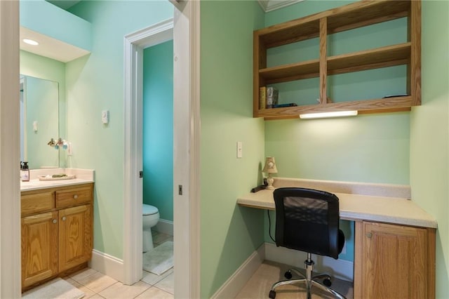 home office featuring built in desk and light tile patterned floors