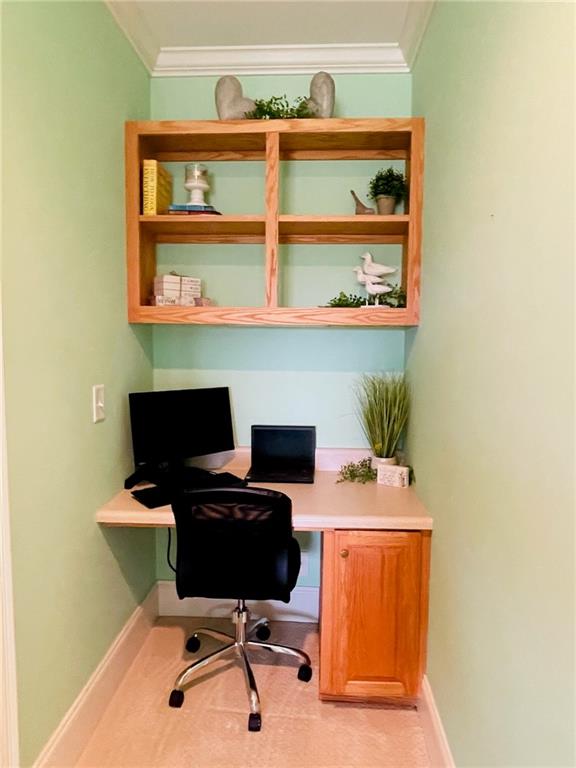 office featuring crown molding and built in desk