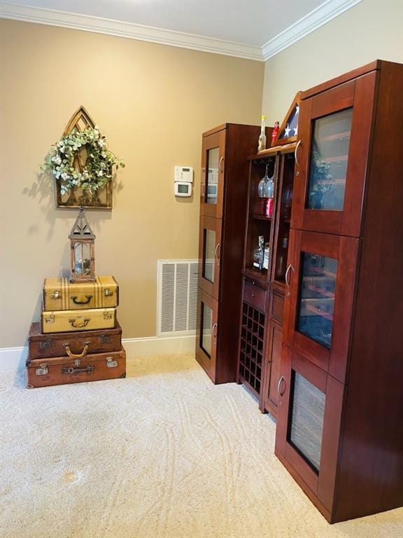 interior space featuring light carpet and ornamental molding