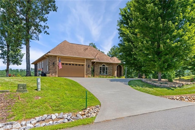 view of front of house featuring a garage and a front lawn