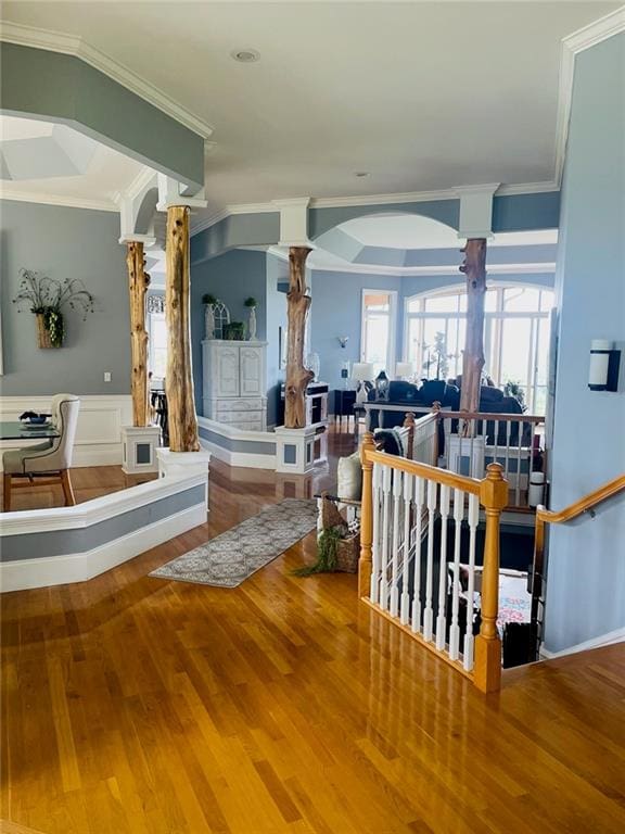 living room with ornamental molding, ornate columns, and hardwood / wood-style floors