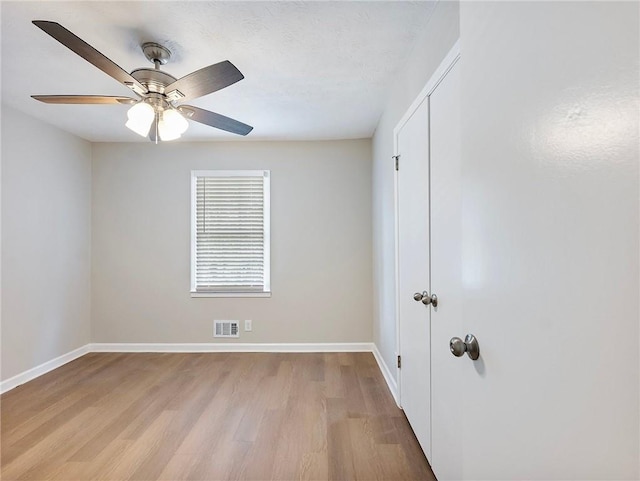 empty room featuring ceiling fan and light hardwood / wood-style flooring