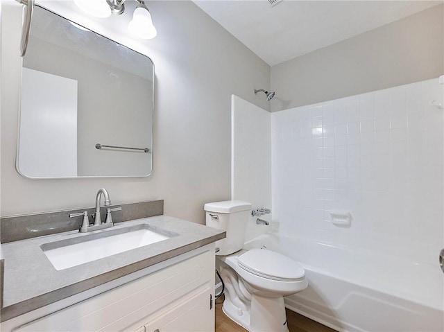 full bathroom featuring vanity, tub / shower combination, and toilet