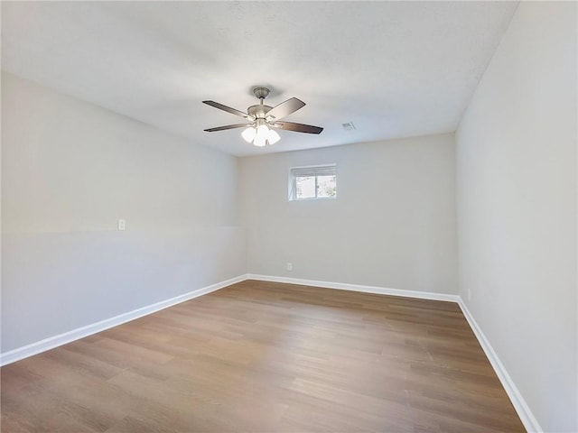 unfurnished room with hardwood / wood-style floors and ceiling fan