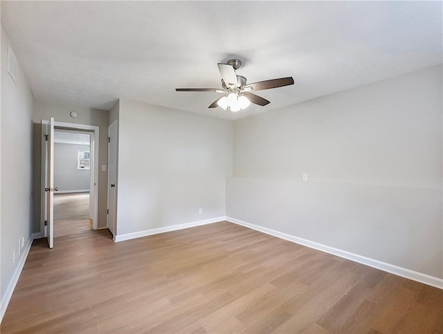 empty room with ceiling fan and light wood-type flooring