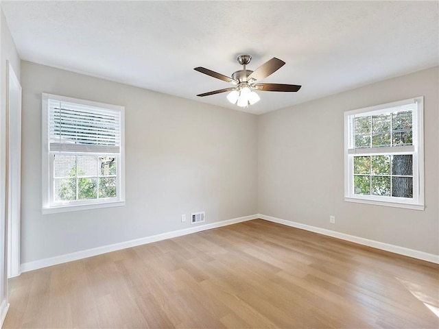 unfurnished room with ceiling fan and light wood-type flooring