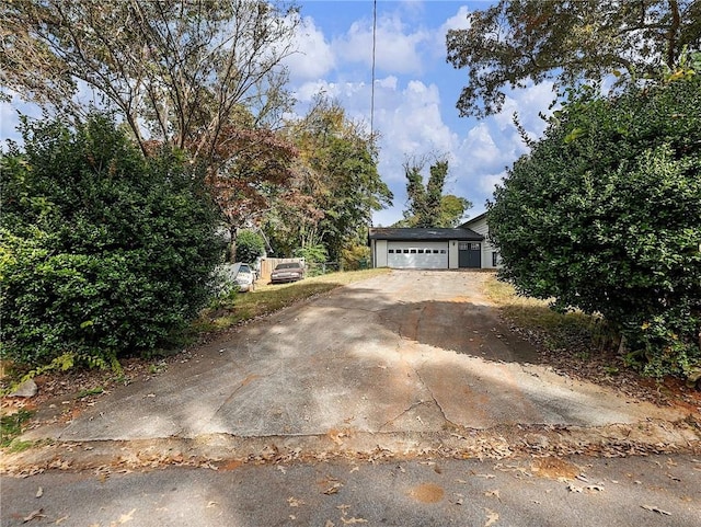 view of property hidden behind natural elements with a garage