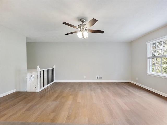 unfurnished room with ceiling fan and light hardwood / wood-style flooring