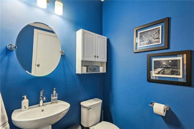 bathroom featuring toilet and a sink