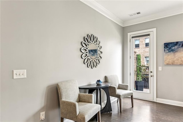 living area featuring ornamental molding, dark wood-type flooring, visible vents, and baseboards