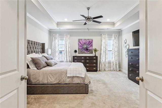 carpeted bedroom featuring a tray ceiling, crown molding, and recessed lighting