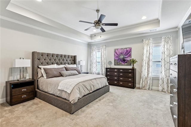 bedroom featuring baseboards, visible vents, a tray ceiling, crown molding, and carpet floors