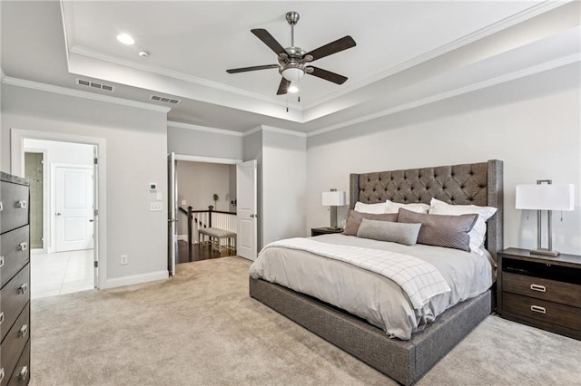 bedroom with light carpet, a raised ceiling, and visible vents