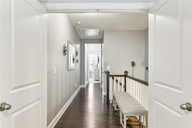 hall featuring dark wood-type flooring, an upstairs landing, and baseboards