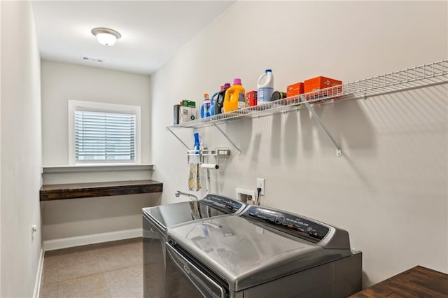 laundry area featuring laundry area, visible vents, baseboards, and separate washer and dryer