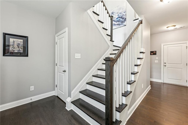 stairway featuring baseboards and wood finished floors