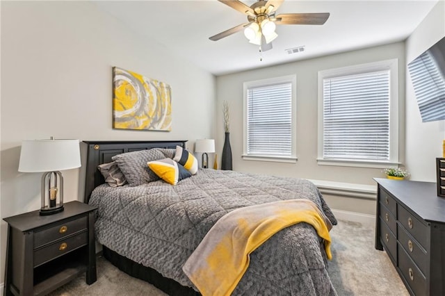 carpeted bedroom with ceiling fan, visible vents, and baseboards