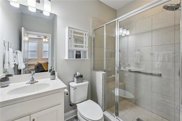 full bathroom featuring vanity, a stall shower, ensuite bath, and toilet