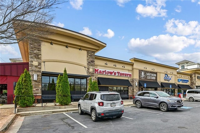 view of property featuring uncovered parking