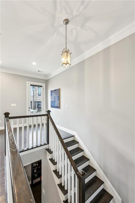 stairway with ornamental molding, recessed lighting, baseboards, and wood finished floors