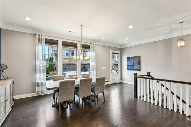 dining space featuring visible vents, a chandelier, dark wood-type flooring, and ornamental molding