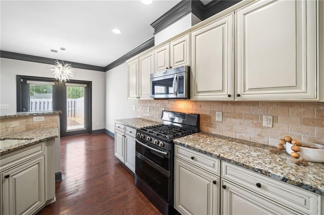 775 Duberry St, Alpharetta, GA 30004 - kitchen featuring range with two ovens, stainless steel microwave, ornamental molding, a chandelier, and tasteful backsplash