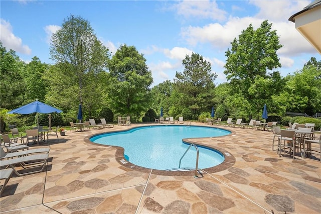 775 Duberry St, Alpharetta, GA 30004 - community pool featuring a patio area, view of scattered trees, and outdoor dining space