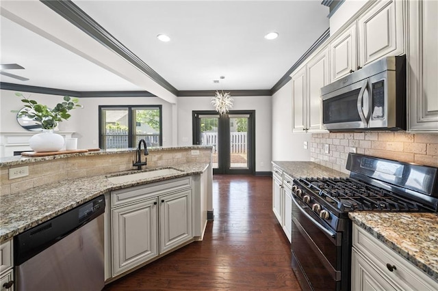 775 Duberry St, Alpharetta, GA 30004 - kitchen with stainless steel appliances, a sink, tasteful backsplash, crown molding, and light stone counters