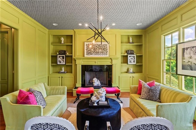 living room featuring a wealth of natural light, built in features, and light hardwood / wood-style floors