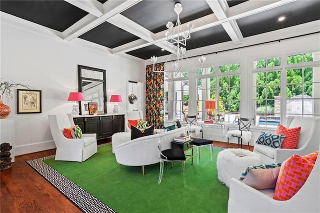 living room featuring beamed ceiling, coffered ceiling, dark wood-type flooring, and an inviting chandelier