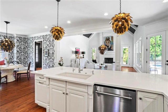 kitchen featuring sink, white cabinetry, stainless steel dishwasher, ornamental molding, and dark hardwood / wood-style flooring