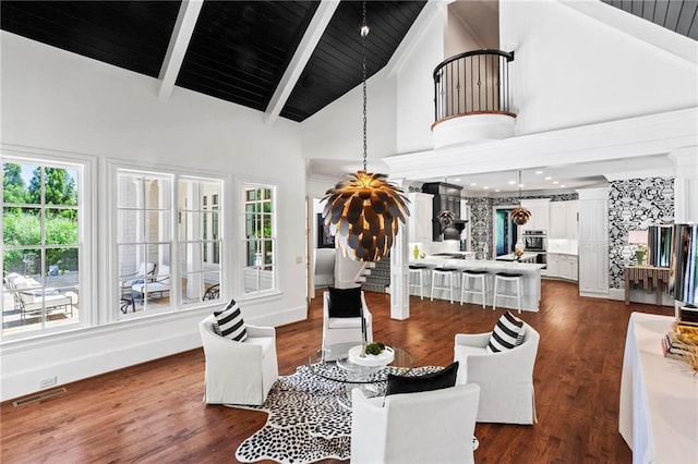 dining area with dark wood-type flooring, beam ceiling, high vaulted ceiling, decorative columns, and wooden ceiling