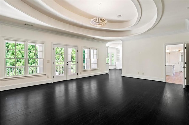 unfurnished living room with french doors, a tray ceiling, crown molding, and hardwood / wood-style flooring