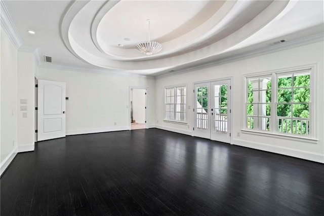 unfurnished living room with hardwood / wood-style floors, a chandelier, a raised ceiling, crown molding, and french doors