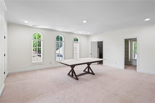 game room with ornamental molding and light colored carpet