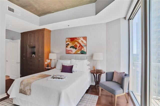 855 Peachtree St NE Unit 1311, Atlanta, GA 30308 - bedroom with baseboards and dark wood-type flooring