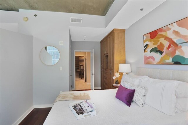 855 Peachtree St NE Unit 1311, Atlanta, GA 30308 - bedroom featuring multiple windows, wood finished floors, floor to ceiling windows, and baseboards