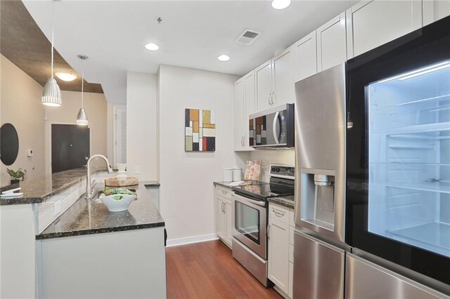 855 Peachtree St NE Unit 1311, Atlanta, GA 30308 - kitchen featuring stainless steel dishwasher, a peninsula, a sink, dark wood-type flooring, and recessed lighting