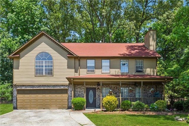 475 Shadetree Ln, Lawrenceville, GA 30044 - view of front facade featuring a porch, a chimney, concrete driveway, a garage, and stone siding