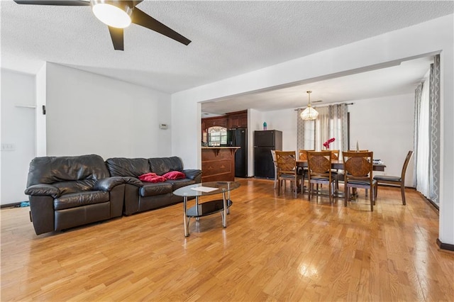 475 Shadetree Ln, Lawrenceville, GA 30044 - living room with light wood finished floors, a ceiling fan, and a textured ceiling