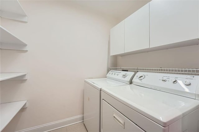 laundry room featuring cabinets and independent washer and dryer